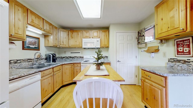 kitchen with white appliances, light hardwood / wood-style floors, sink, and light brown cabinetry