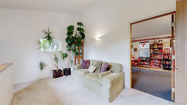 carpeted living room featuring lofted ceiling