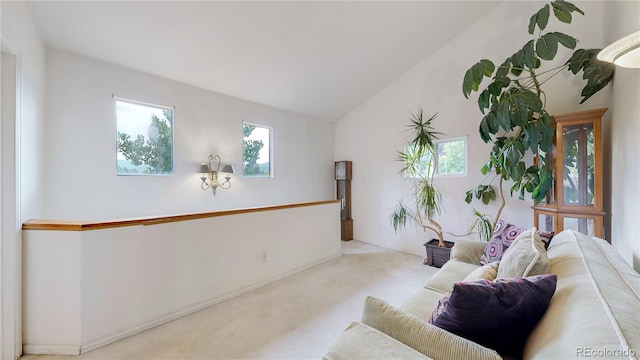 living room featuring lofted ceiling and light carpet