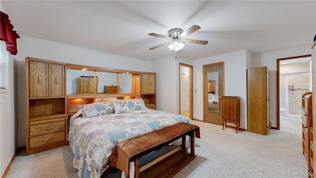 bedroom with ceiling fan, connected bathroom, and light carpet