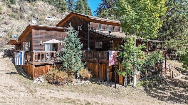 back of property with a wooden deck