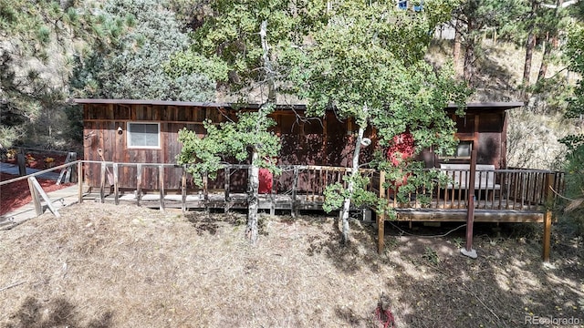 rear view of house with a wooden deck