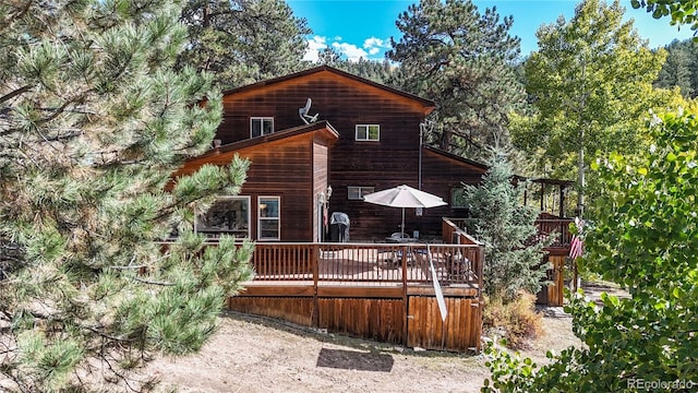 rear view of house with a wooden deck