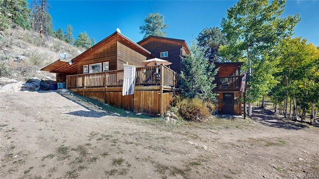 rear view of property with a wooden deck