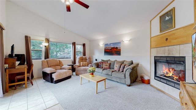 living room with a fireplace, light tile patterned flooring, high vaulted ceiling, and ceiling fan