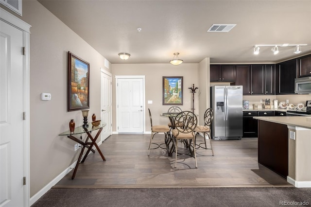 9258 Rockhurst St Unit 303, Highlands Ranch, CO 80129 - kitchen with appliances with stainless steel finishes, light wood finished floors, light countertops, baseboards, and dark brown cabinets