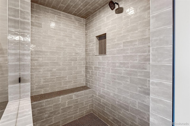 bathroom with a tile shower