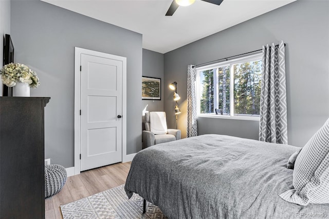 bedroom with ceiling fan and light hardwood / wood-style floors