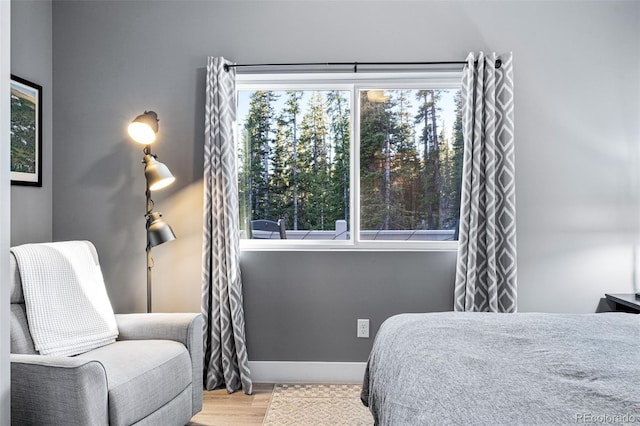 bedroom featuring light hardwood / wood-style flooring and multiple windows