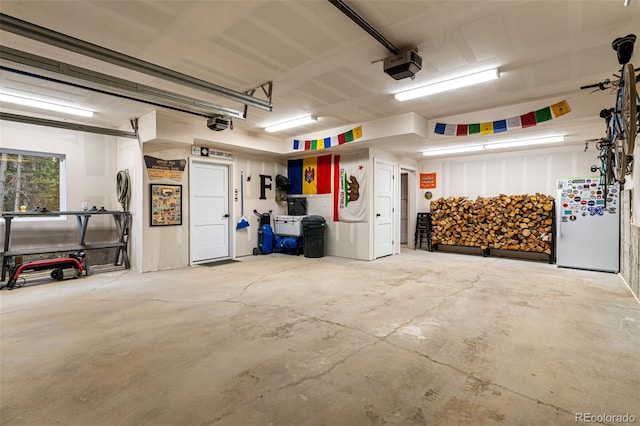 garage with white fridge and a garage door opener