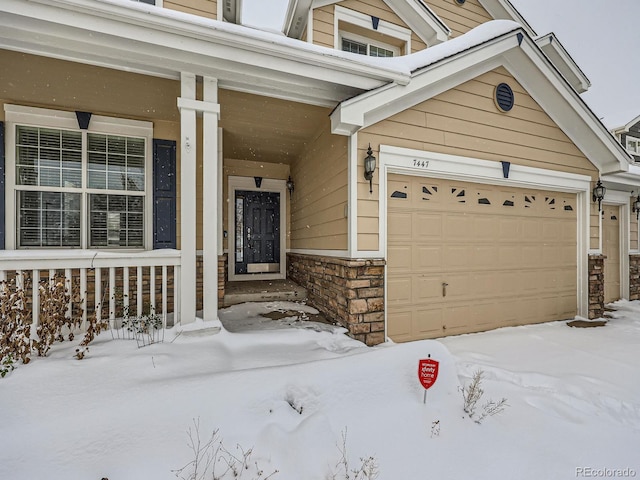 view of snow covered property entrance