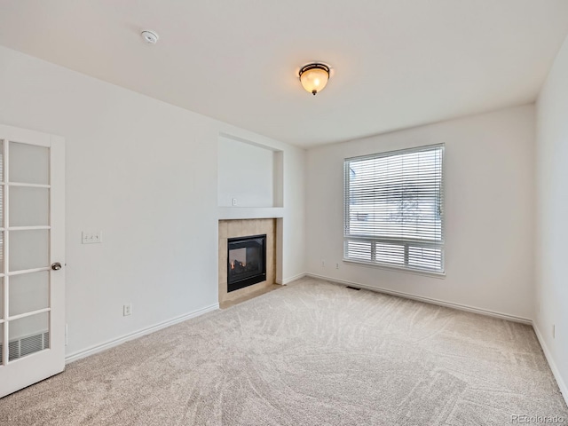 unfurnished living room featuring a fireplace and light carpet