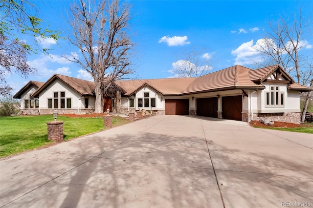 single story home with an attached garage, stone siding, a tile roof, concrete driveway, and a front lawn