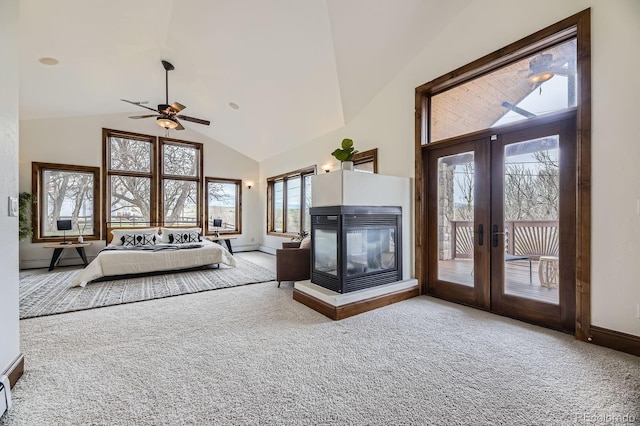 living area featuring high vaulted ceiling, carpet, a multi sided fireplace, and ceiling fan