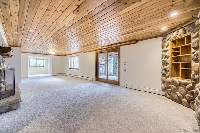 unfurnished living room featuring a stone fireplace, carpet flooring, a baseboard heating unit, and wood ceiling