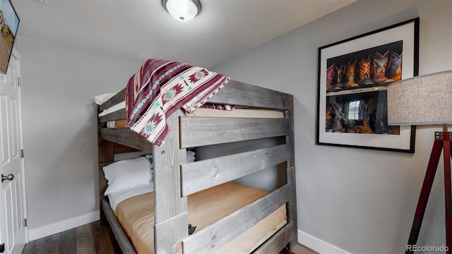 bedroom with wood finished floors and baseboards