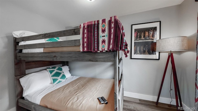 bedroom featuring baseboards and wood finished floors