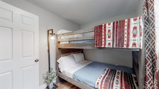 bedroom with wood-type flooring