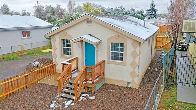 exterior space featuring a fenced backyard and stucco siding