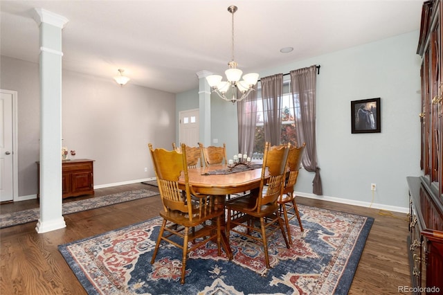 dining space with baseboards, wood finished floors, and ornate columns