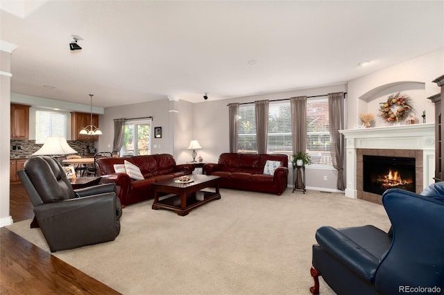 carpeted living room with a tile fireplace and plenty of natural light