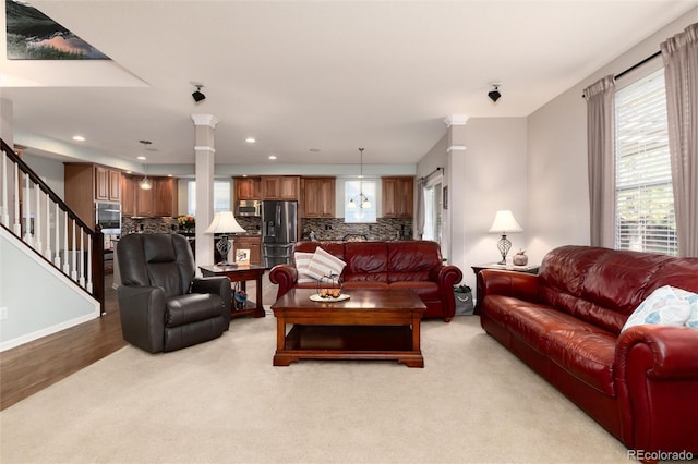 living room featuring recessed lighting, decorative columns, stairway, and baseboards