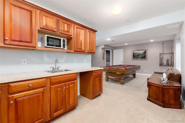 kitchen featuring pool table, light carpet, and sink