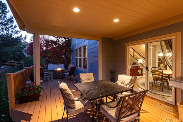 wooden deck featuring an outdoor fire pit