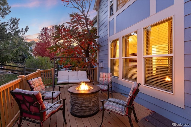 deck at dusk with an outdoor fire pit