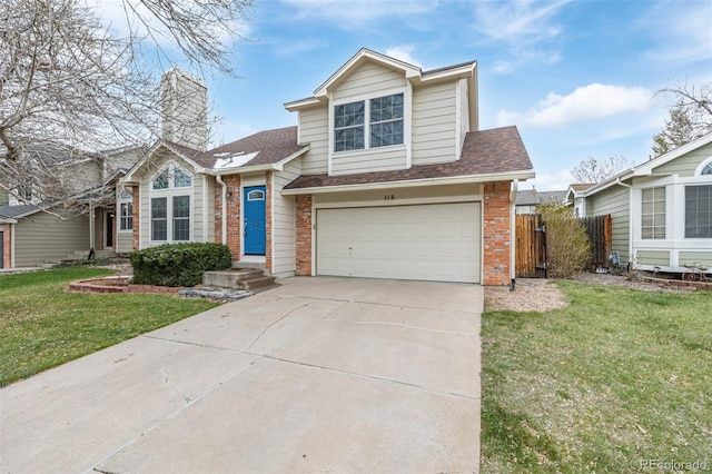 view of front of house with an attached garage, fence, brick siding, a front lawn, and driveway