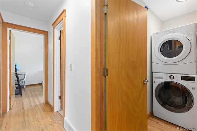 270 31st St, Boulder, CO 80305 - washroom with stacked washing machine and dryer, light wood-type flooring, and baseboards