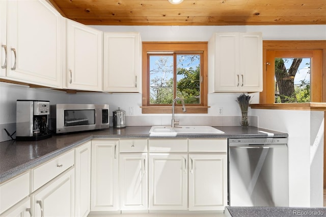 270 31st St, Boulder, CO 80305 - kitchen with stainless steel appliances, a sink, white cabinetry, and wooden ceiling