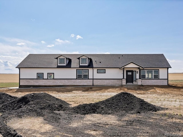 view of front of house featuring roof with shingles