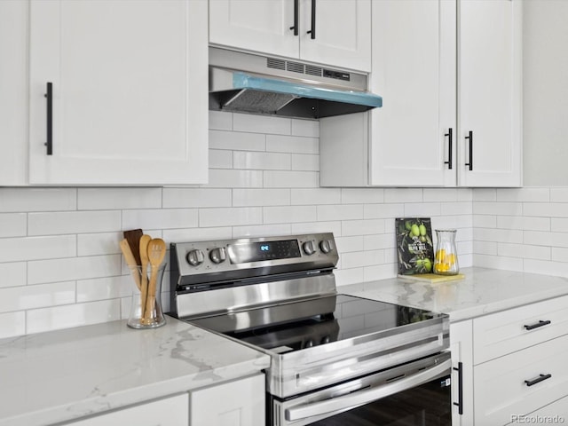 kitchen with backsplash, stainless steel range with electric cooktop, under cabinet range hood, and white cabinetry