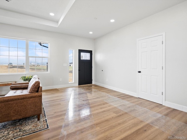 foyer entrance with recessed lighting, light wood-style flooring, and baseboards