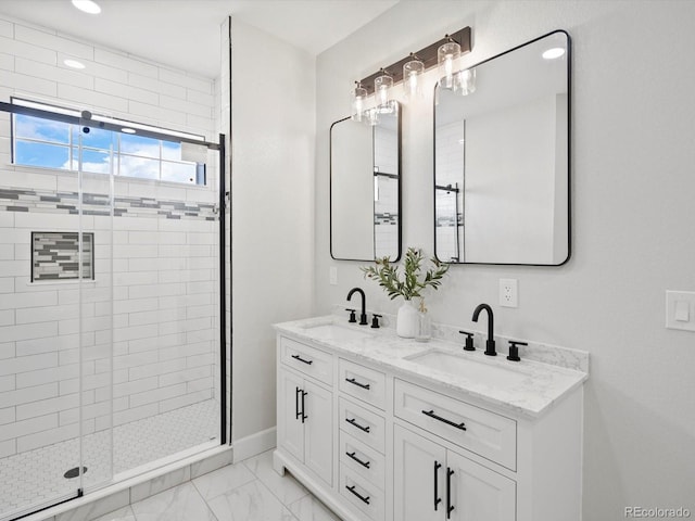 full bath with double vanity, a shower stall, marble finish floor, and a sink