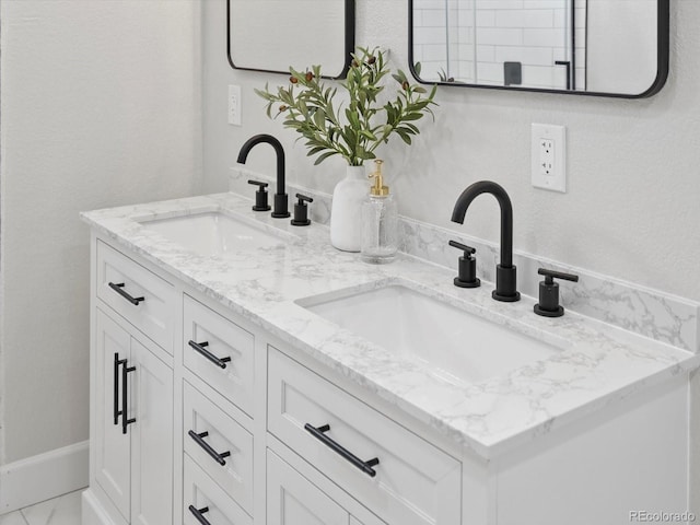 bathroom featuring double vanity and a sink