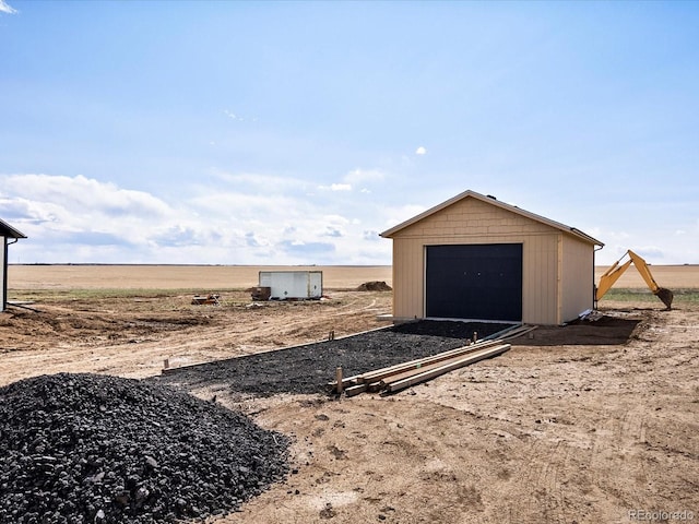 view of shed with dirt driveway