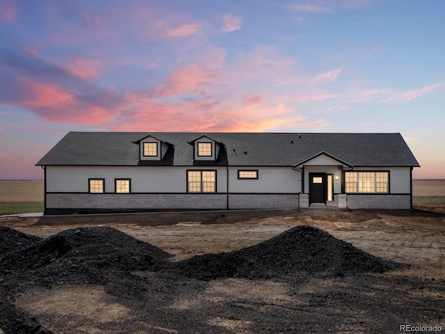 modern farmhouse style home featuring roof with shingles