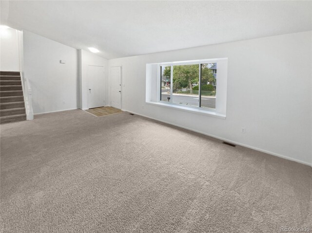 18306 E Gunnison Pl, Aurora, CO 80017 - carpeted spare room with lofted ceiling and stairway