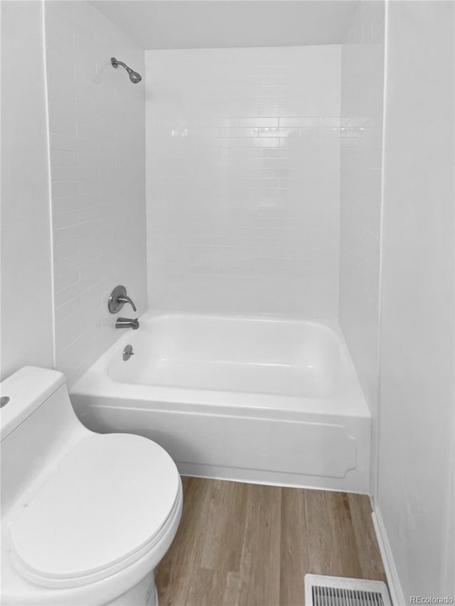 18306 E Gunnison Pl, Aurora, CO 80017 - bathroom featuring wood finished floors and tub / shower combination
