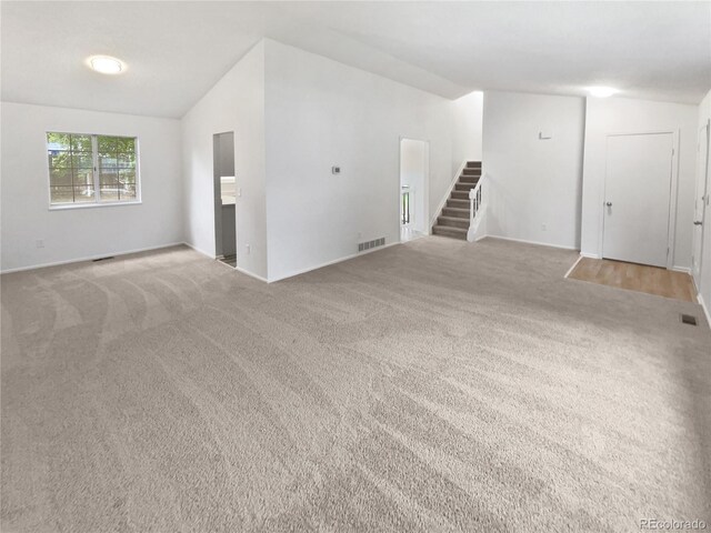 18306 E Gunnison Pl, Aurora, CO 80017 - spare room with vaulted ceiling, carpet, and stairway