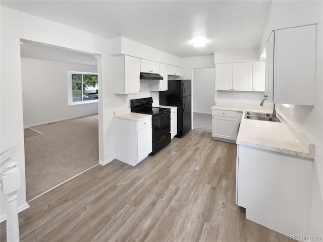18306 E Gunnison Pl, Aurora, CO 80017 - kitchen featuring black appliances, light countertops, white cabinets, under cabinet range hood, and light wood-style floors