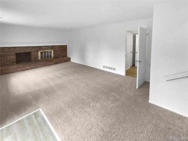 18306 E Gunnison Pl, Aurora, CO 80017 - unfurnished living room with carpet flooring and a fireplace