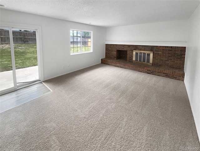 18306 E Gunnison Pl, Aurora, CO 80017 - unfurnished living room featuring a fireplace, carpet, and a textured ceiling