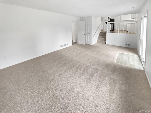 18306 E Gunnison Pl, Aurora, CO 80017 - unfurnished living room featuring stairway and carpet floors