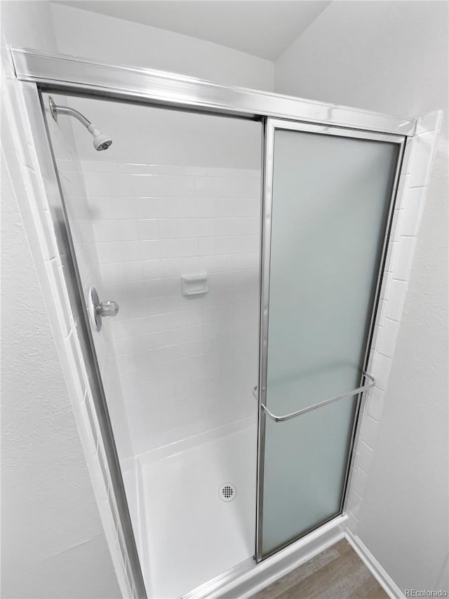 18306 E Gunnison Pl, Aurora, CO 80017 - bathroom with a stall shower and wood finished floors