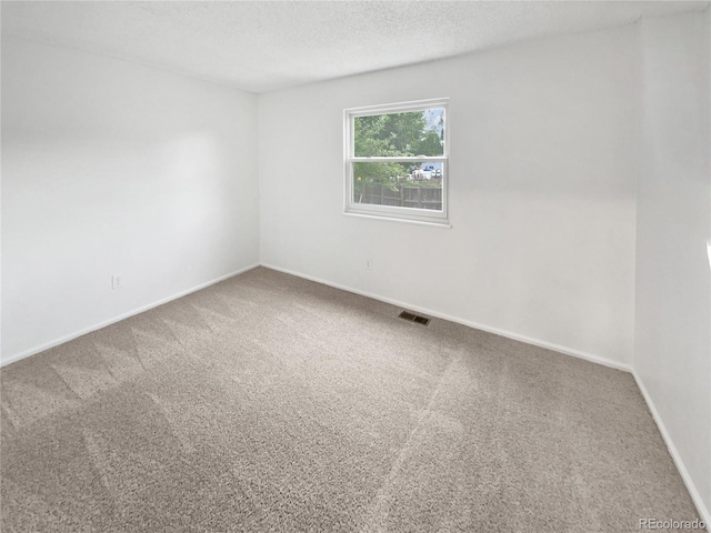 18306 E Gunnison Pl, Aurora, CO 80017 - empty room featuring carpet and a textured ceiling