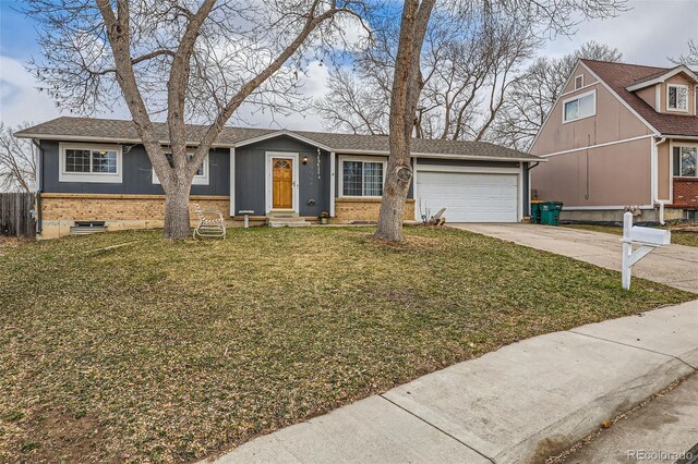 view of front of home with a front yard, driveway, an attached garage, entry steps, and brick siding