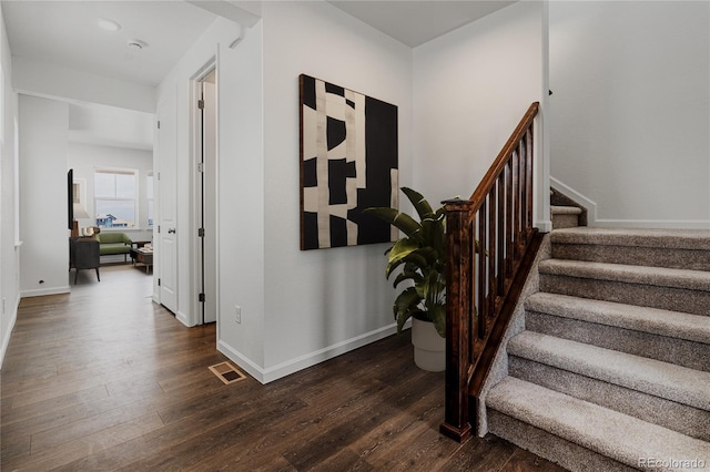 stairway with hardwood / wood-style floors